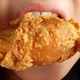 Up-close shot of mouth eating fried chicken
